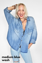 Woman wearing a medium blue denim shirt and jeans on a white background