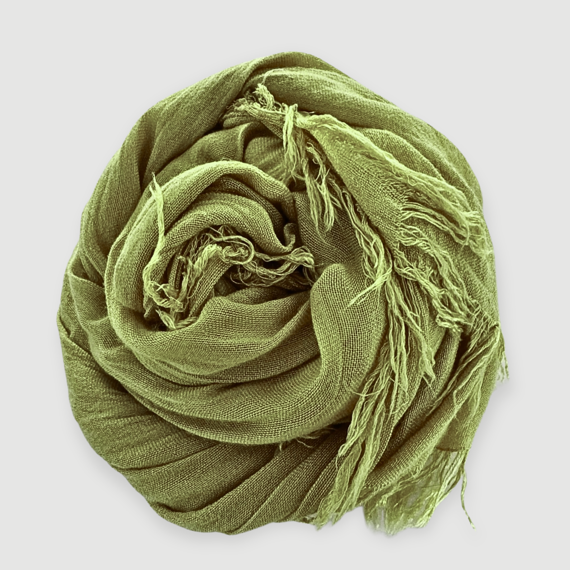 Green scarf with frayed edges on a light gray background