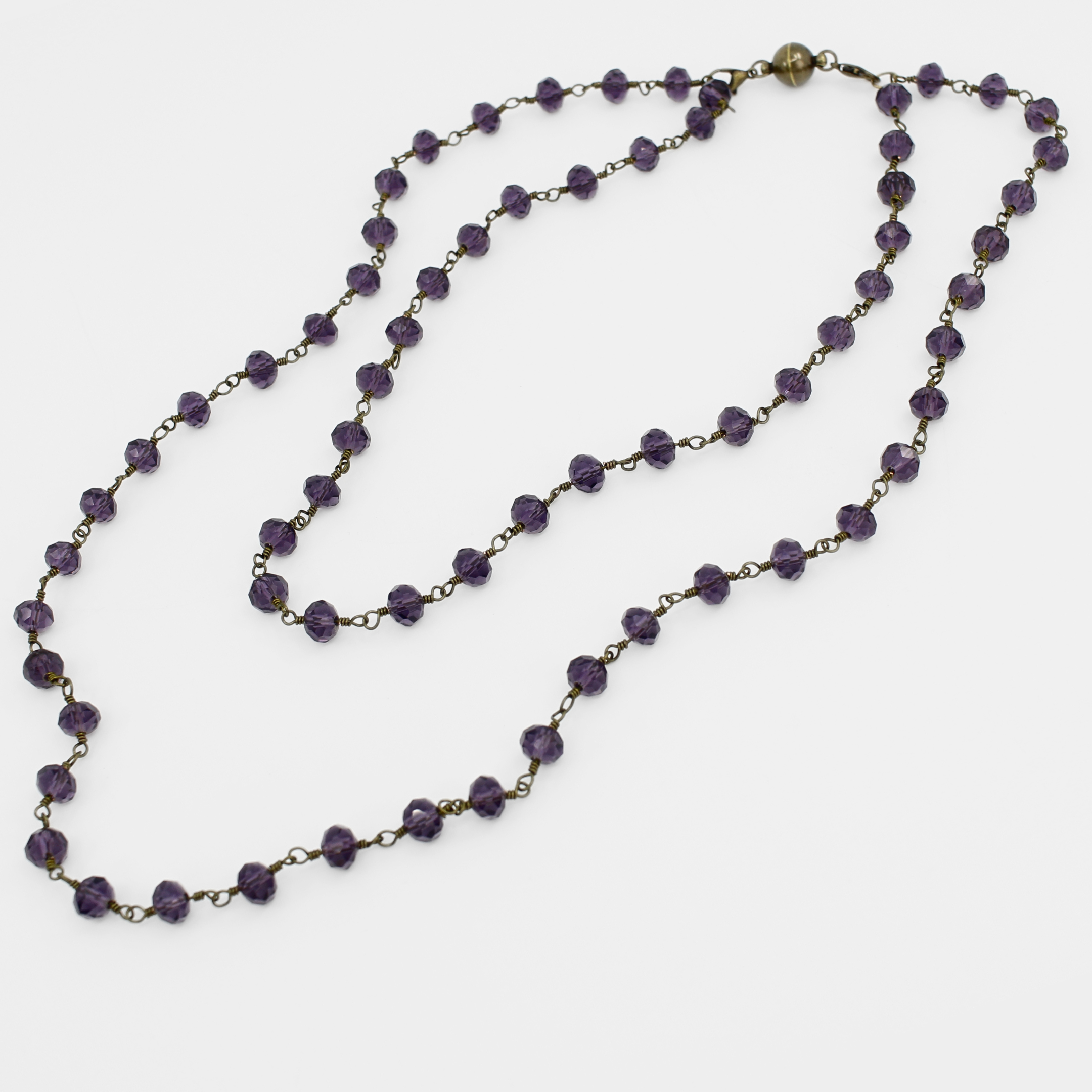 Purple beaded necklace on a white background