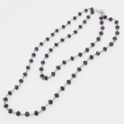 Purple beaded necklace on a white background