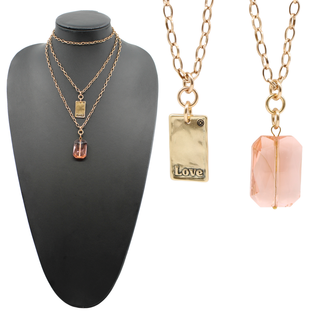 A black jewelry display showcases an elegant chain necklace: one features a peach crystal stone pendant, while the other flaunts a gold LOVE pendant. Separate close-ups capture the intricate beauty of both pendants.