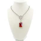 Necklace with a red pendant on a white mannequin bust
