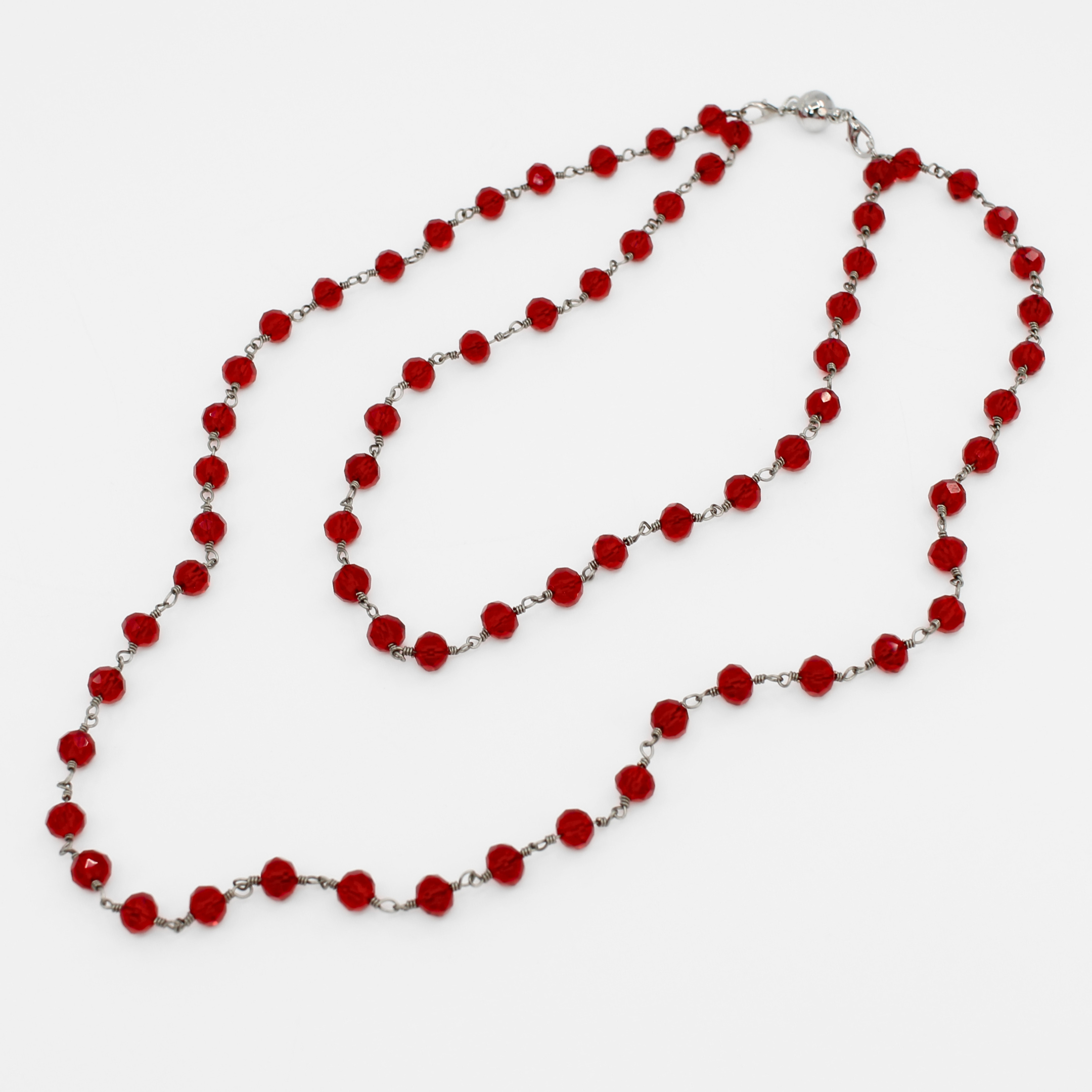Red beaded necklace on a white background