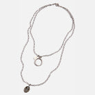 Silver necklace with pendant on a white background