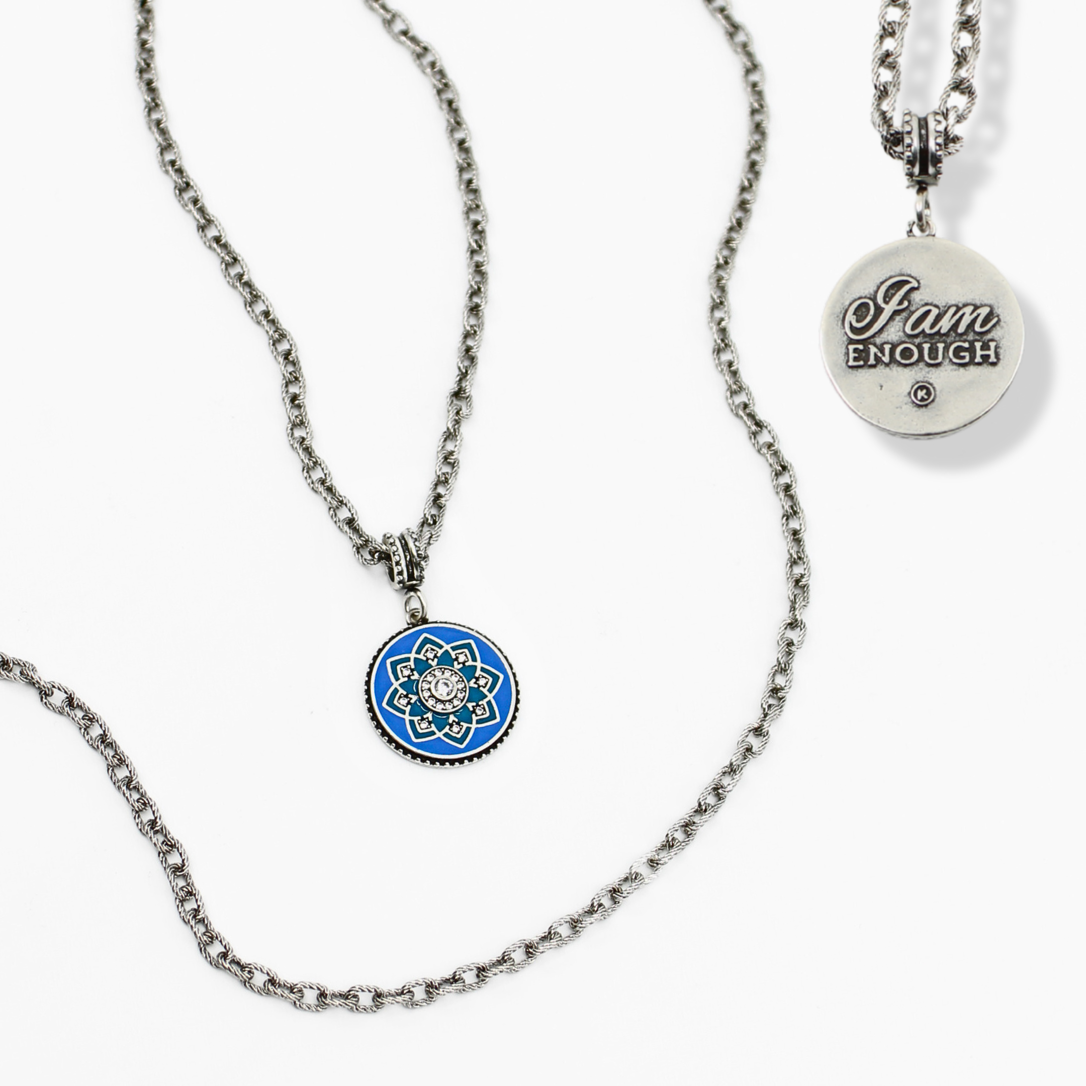 Necklace with blue pendant and 'I am enough' charm on a white background