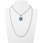 Necklace with a blue and silver pendant on a mannequin bust against a white background