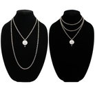 Two chain necklaces with round pendants: one silver with LISTEN adorned in plated brass and small beads, the other silver featuring a face design. Each piece exudes charm, enhanced by subtle crystal accents.