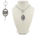 Silver necklace with pendant on a white mannequin bust