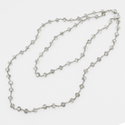 Silver beaded necklace on a white background