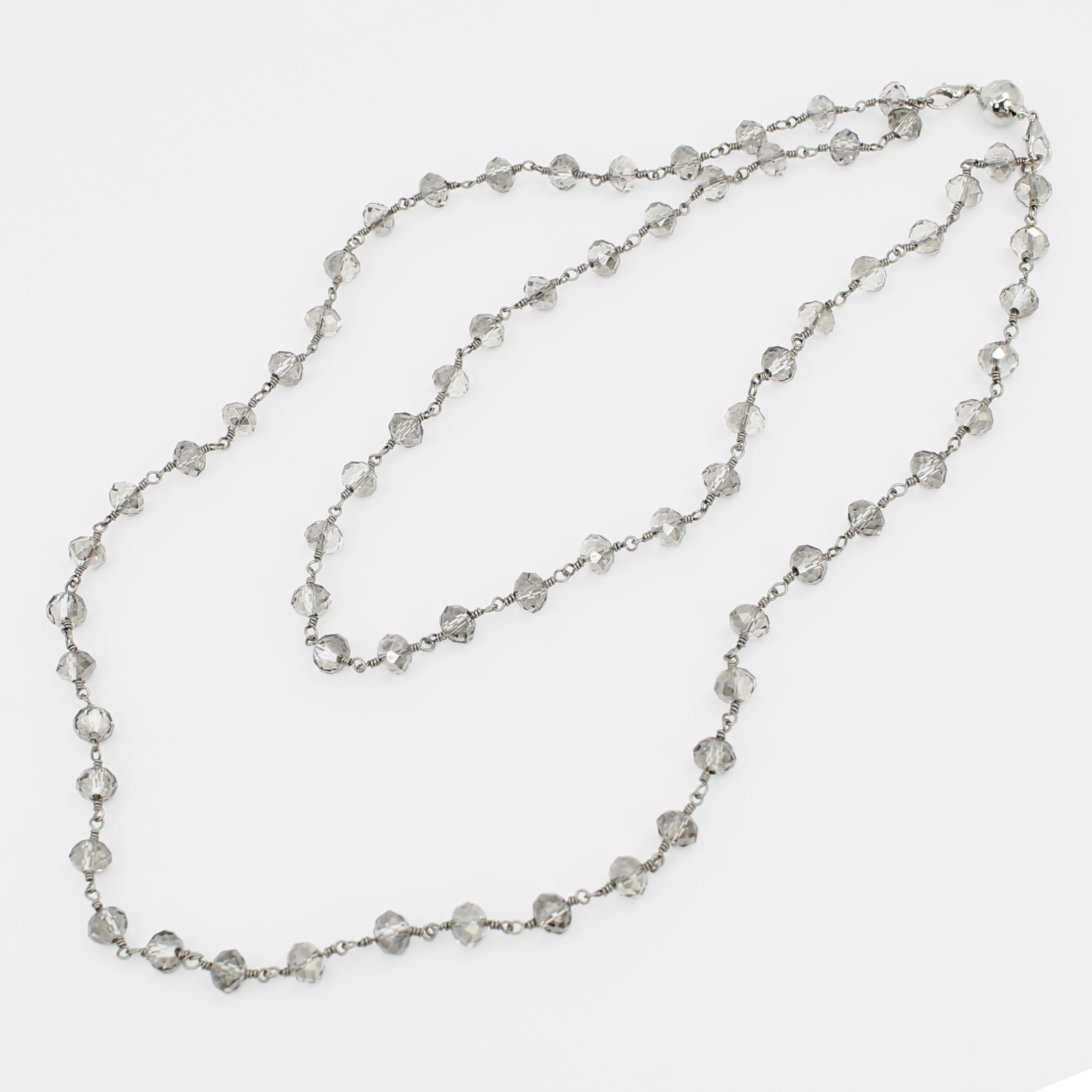 Silver beaded necklace on a white background