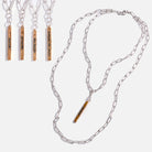 Silver chain necklace with personalized engraved bars on a white background.