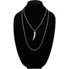 tusk-shaped pendants, crafted from synthetic polymer, hang gracefully from mixed metal design chain necklaces of silver and bronze, displayed side by side on a white background.