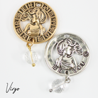 Two necklaces with gold and silver chains, featuring circular pendants with zodiac signs, and faceted crystal quartz accents.