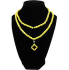 multiple colorful beaded boho wrap bracelets in 4 bright colors made with howlite beads. this image shows the yellow one on a black bust worn as a necklace